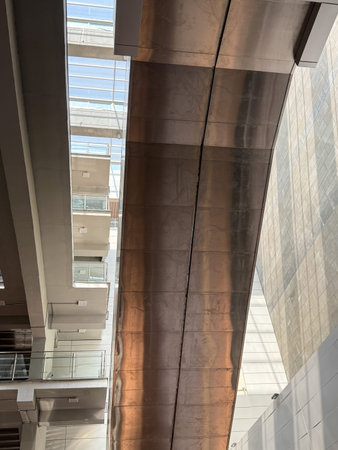 A long, narrow metal structure with a shiny, metallic surface. The structure is suspended above a...