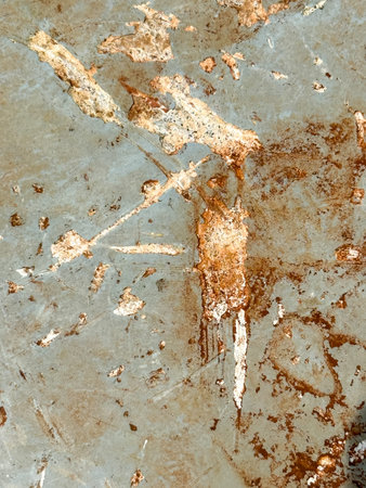 A wall with a lot of scratches and marks on it. The wall is made of metal and has a brownish color