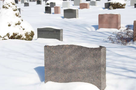 headstone monuments in cemetery during winterの写真素材