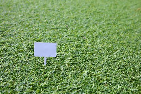 Sign on grass, green lawn, with space for caption, dreamy colorの写真素材