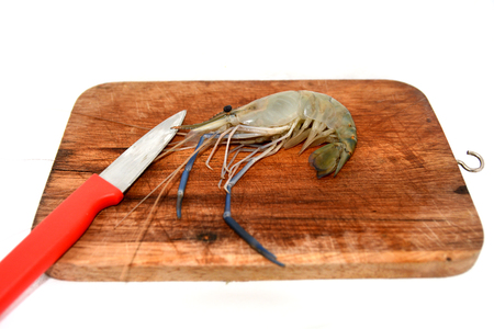 a raw shrimp on cutting boardの写真素材