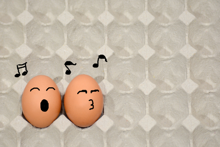 sing a song happily, fresh eggs in paper panelの写真素材