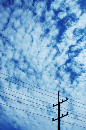 electricity post with blue sky in backgroundの写真素材