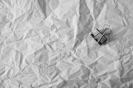 Paper clip put on the crumpled white paper as background, idea photoの写真素材