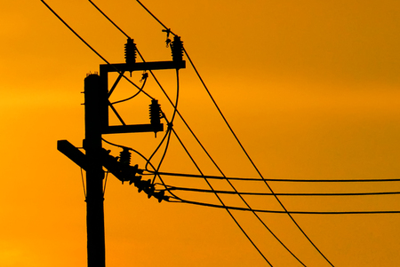 High-voltage tower at sky background,high voltage post at sky backgound, Silhouette of pylons,Electricity pylons and linesの写真素材