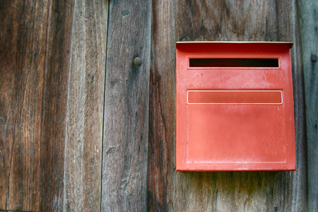 Red mailbox with wood wall, red letter box with wood wallの写真素材