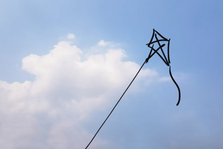 focus on hand drawn Playing kite  from imagine and  clound and  blue sky is background
