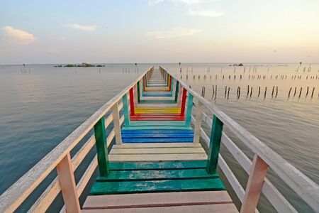 colorful  rainbow wooden bridge by the seaの写真素材