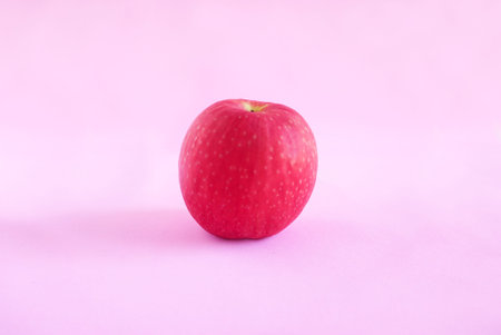 apple on the pink backgroundの写真素材