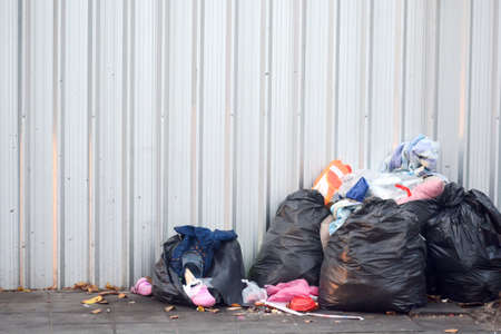 lots of garbage on the footpath beside the roadのeditorial素材