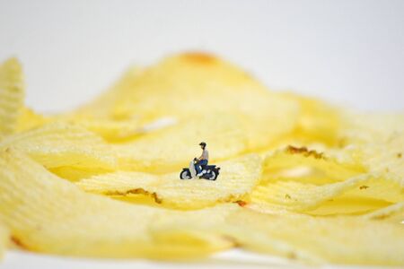 model riding an old motorcycle on potato shipの写真素材