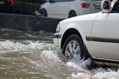 more floods and flooded cars ,car driving flood water on a roadのeditorial素材
