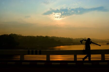 silhouette photographer on bridgeの写真素材