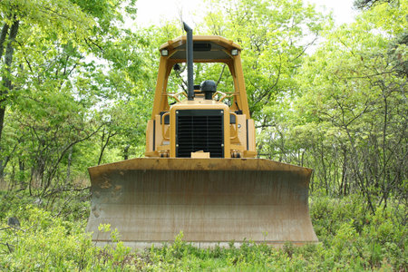 an image of a Yellow bulldozer in the woods.の写真素材