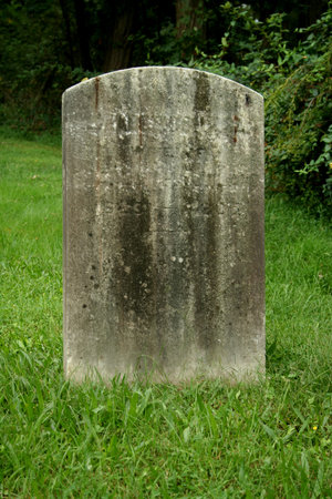 Old Gravestone with grass in a graveyardの写真素材