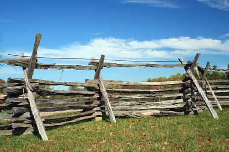 A Stacked wood fence against blue skyの写真素材