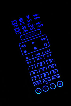 A Isolated lighted  TV remote control on black