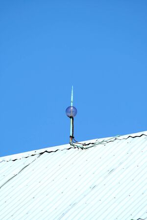 Lightning rod on top of a barn against a blue skyの写真素材