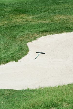 Golf rake in a sand trapの写真素材