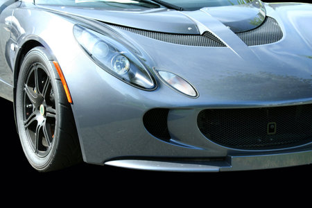 A isolated blue sports car on black