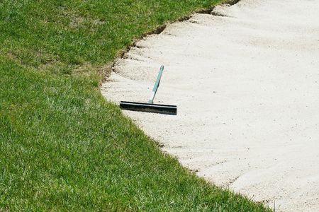A Sand trap rake in a bunkerの写真素材