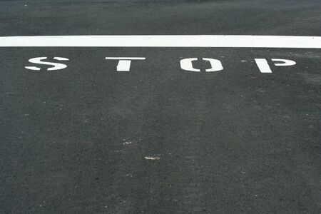 A stop sign painted on the streetの写真素材
