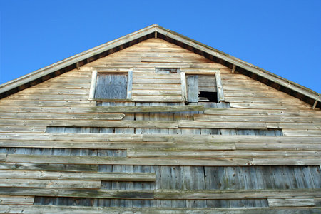 A Old wooden barn with blue sky