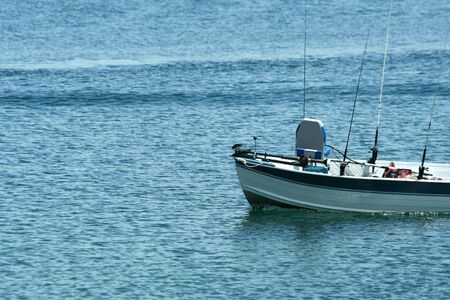 A fishing boat on a lakeの写真素材