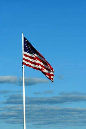 A American flag waving with blue sky