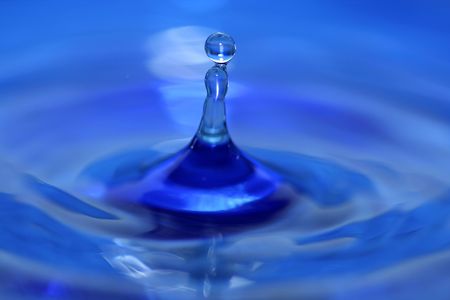 A blue water droplet splashingの写真素材