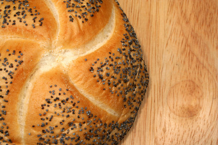 A Fresh bakery roll on a cutting board