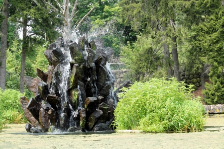 Stone water fountain on a pondの写真素材