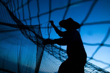 The scattering of fishing during sunset.の写真素材