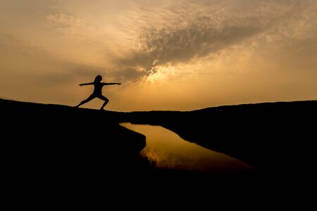 Silhouette woman playing yoga in the morning.の写真素材