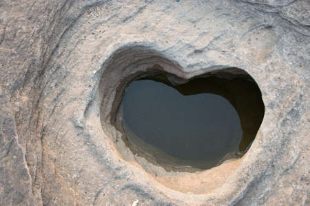 Heart of stone with water inside.の写真素材