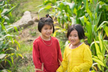 Two girls are happy in cornfield.の写真素材