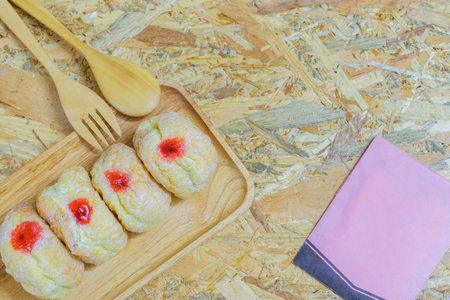Dessert donut bakery on wood disk and on plywood background with cactus.