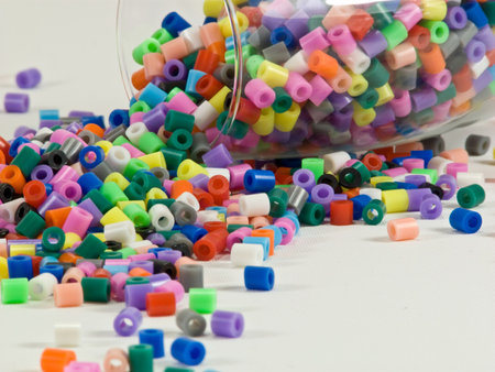 Brightly coloured beads spilling out of glass