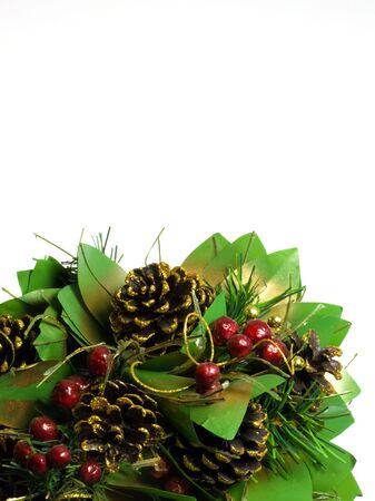Pine cones and red berry floral display on whiteの写真素材