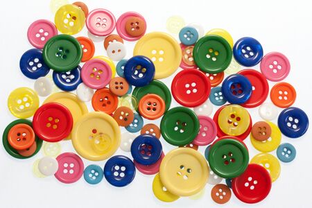 Lots of bright coloured buttons on whiteの写真素材
