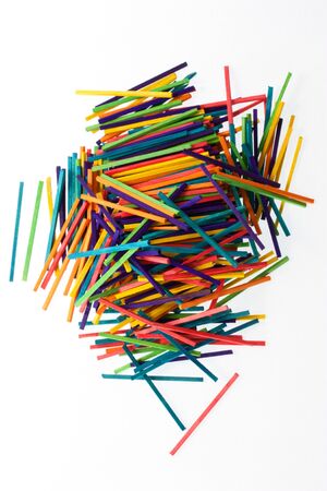A pile of bright coloured sticks on whiteの写真素材