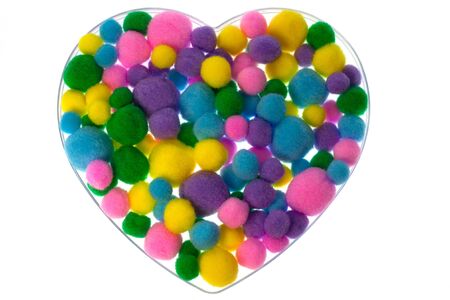 Heart shape filled with colored fluffy ballsの写真素材