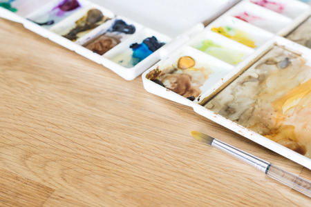 plastic artist color palette on wooden floor art conceptの写真素材