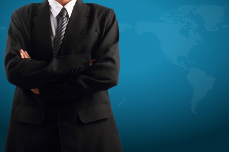 Businessman standing near with map of the world in background の写真素材