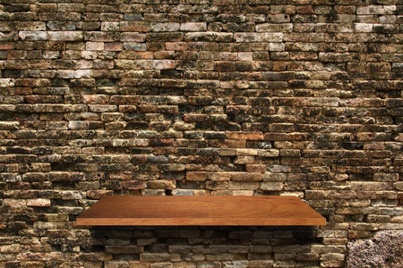 Empty wood shelf on brick wall background