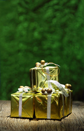 Gift box on old wooden with green bokeh background, Still life grunge lighting version Design...
