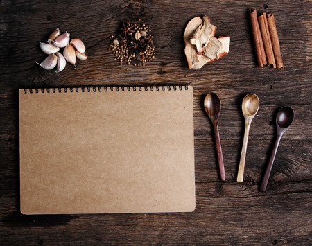 Still life with spices and notebook paper on old wooden tableの写真素材