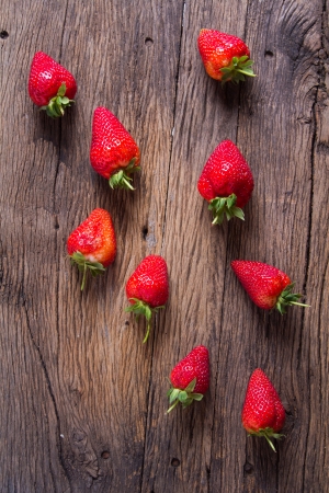 Strawberries on old wooden backgroundの写真素材