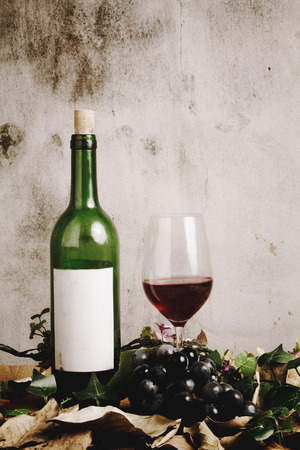 Still life of red wine bottle and wine glassの写真素材