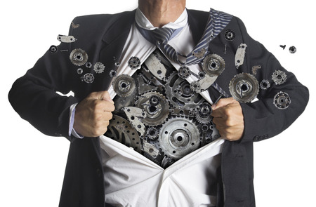 Businessman showing a superhero suit underneath machinery metal gears idea concept, isolated on white background Businessman showing a superhero suit underneath machinery metal gears idea concept, isolated on white background